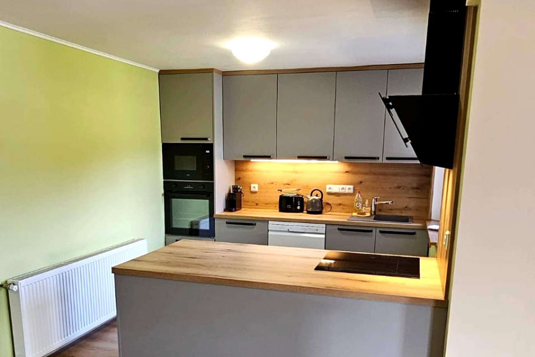 Kuchyňka ve společných prostorech s ostrůvkem a indukční deskou – Apartmány Chaloupka, ubytování Jizerské hory